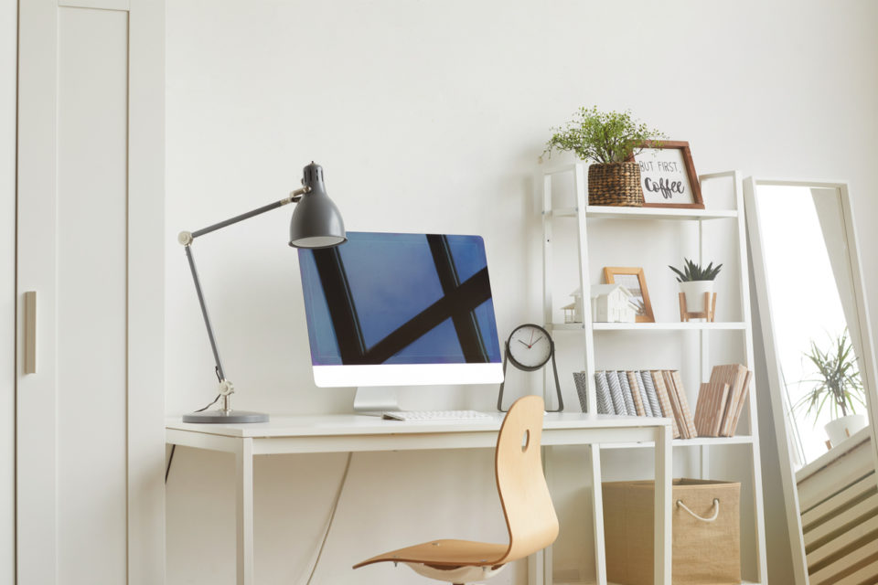 White Background image of empty home office workplace with wooden chair and modern computer on white desk, copy space