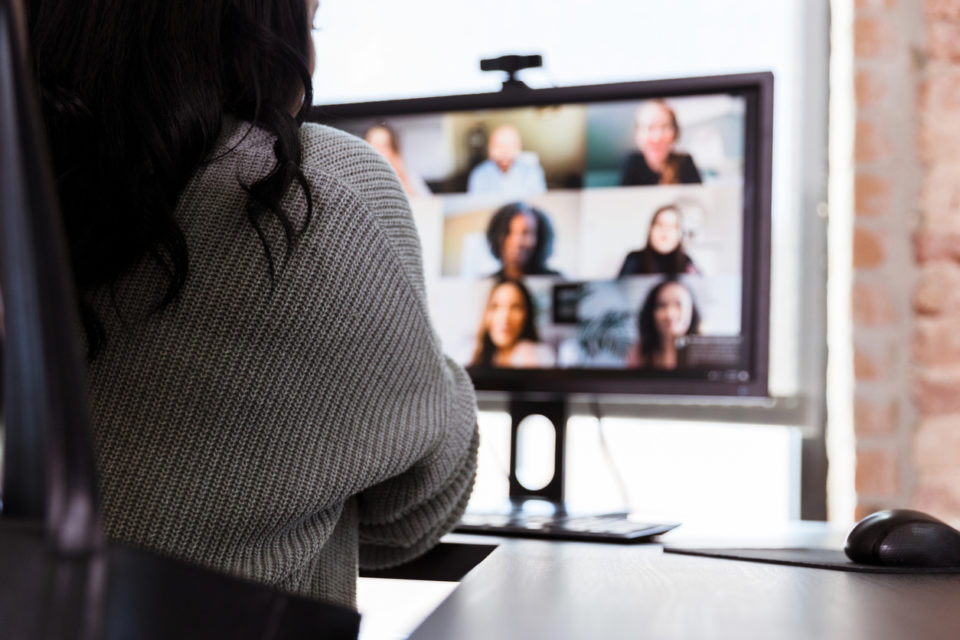 Unrecognizable businesswoman participating in virtual zoom meeting