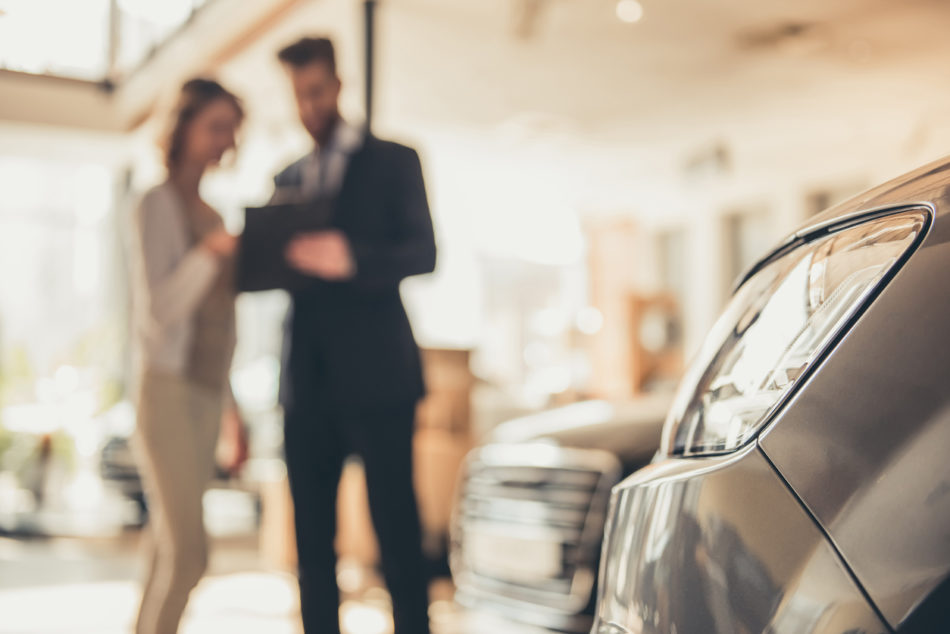 Woman talking to car salesman