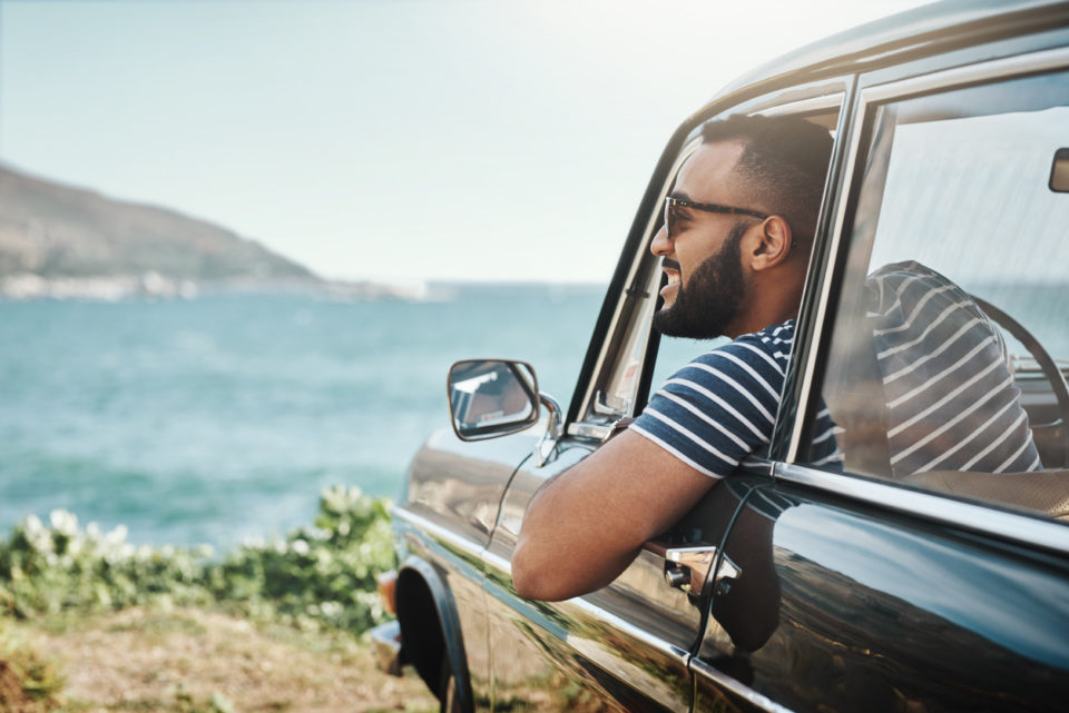 Shot of a young man enjoying a road trip