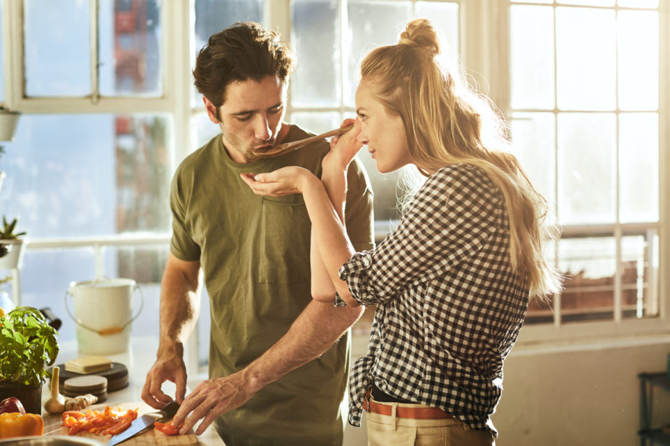 Shot of a young couple preparing a meal together at home