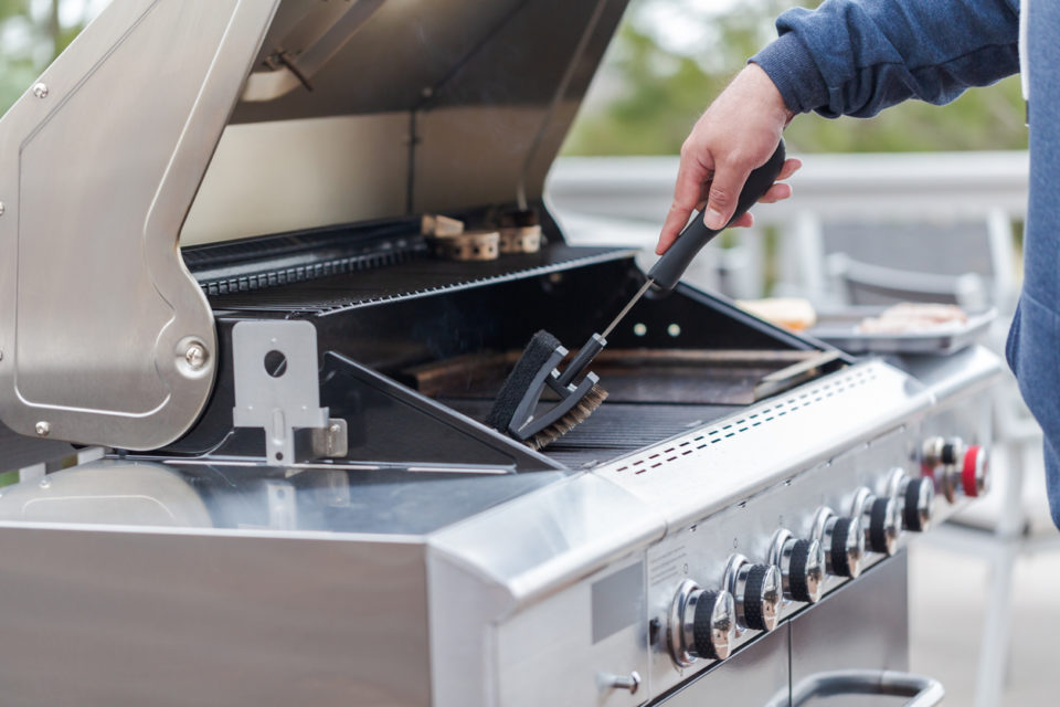 Cleaning outdoor gas grill before next grilling.