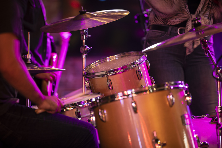 Percussion musician plays the drums during a country music rock concert