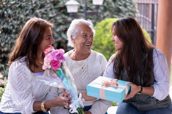 Three generations portrait celebrating motherâs day all smiling very happy - Celebration concepts