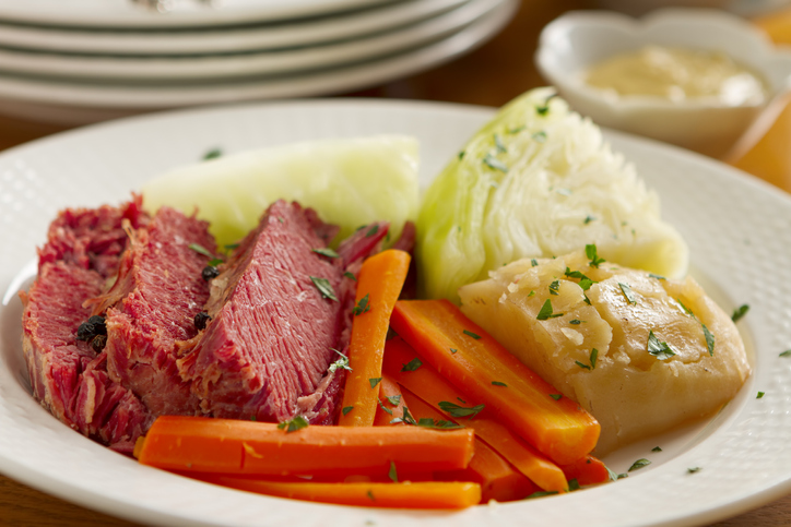 A classic boiled dinner of corned beef, cabbage, potatoes, onions, and carrots.