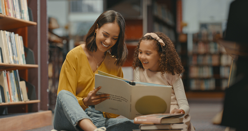 Mom reading with her daughter in the library